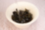 Pouring hot water over loose leaf tea in a gaiwan to show how to make loose leaf tea step by step at home