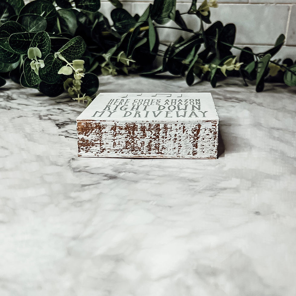 Thumbnail: Square wooden sign with “Here Comes Amazon” text – funny neutral-toned decor for online shoppers