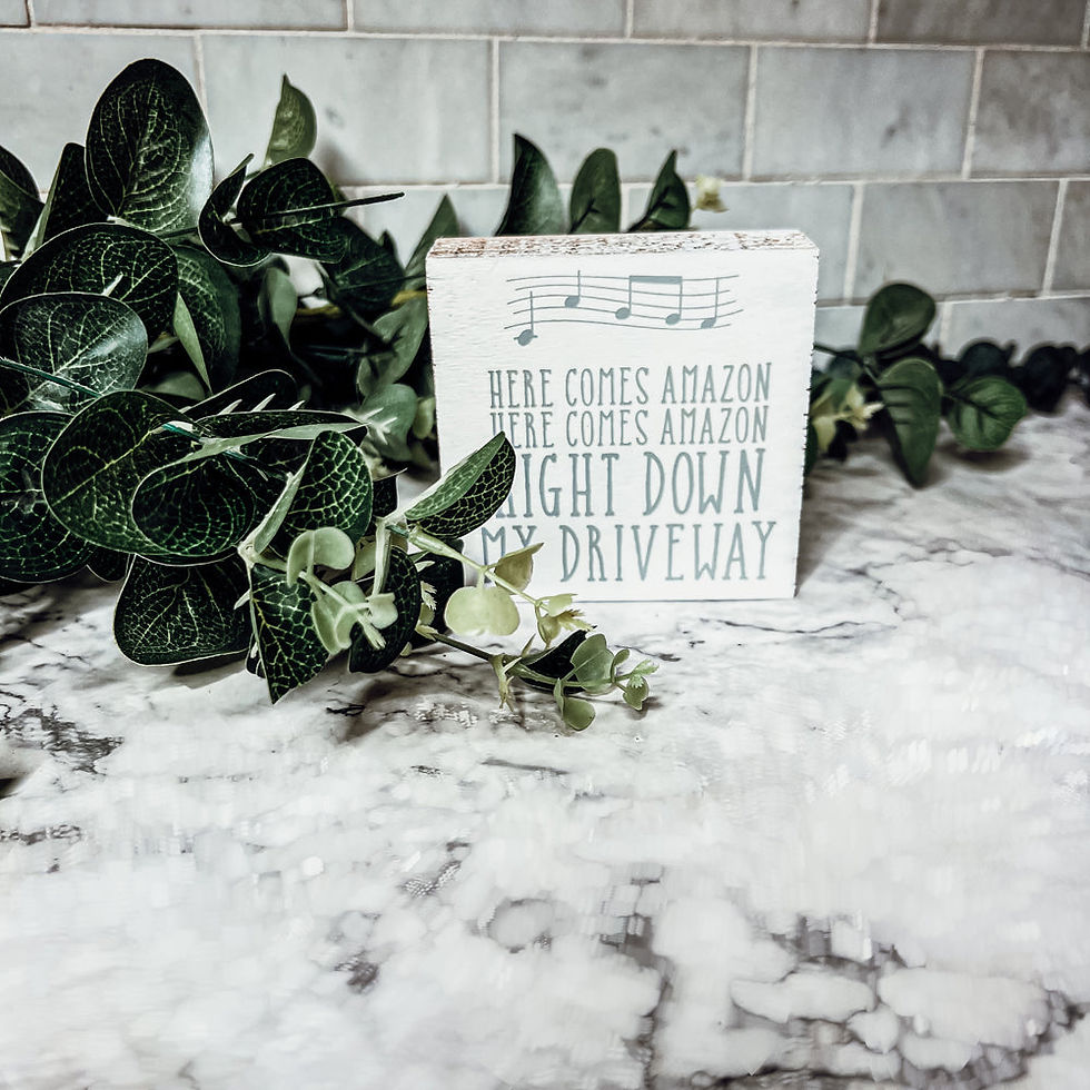 Thumbnail: Square wooden sign with “Here Comes Amazon” text – funny neutral-toned decor for online shoppers