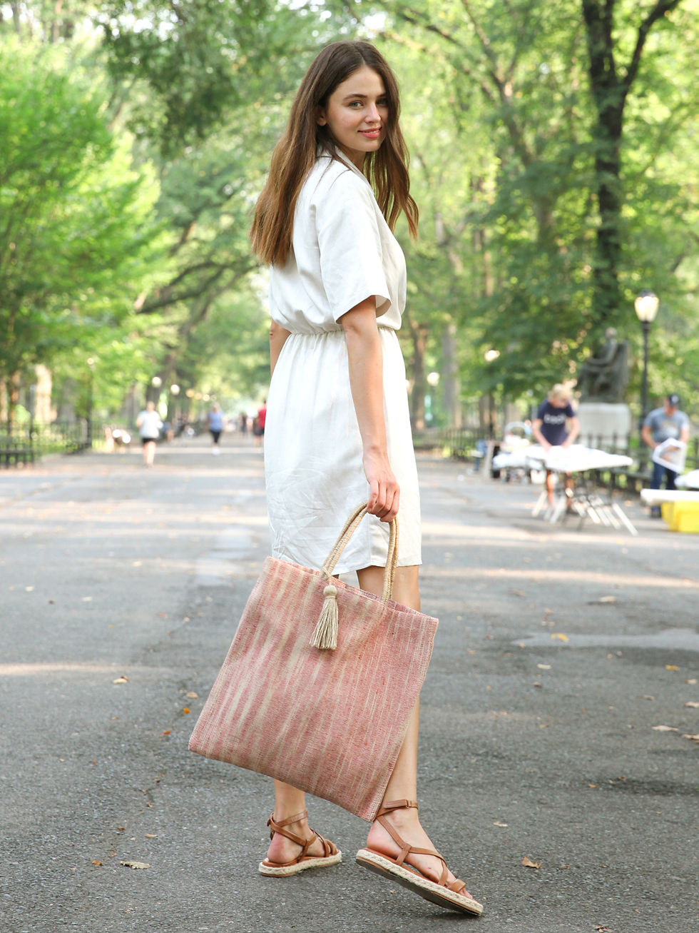 Thumbnail: women carrying a Nadi Jute Tote Bag in red, hand-loomed and naturally dyed, with sturdy handles and a spacious design
