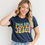 Thumbnail: This Girl Loves Jesus Christian t-shirt for women with a faith-inspired message in a stylish design.