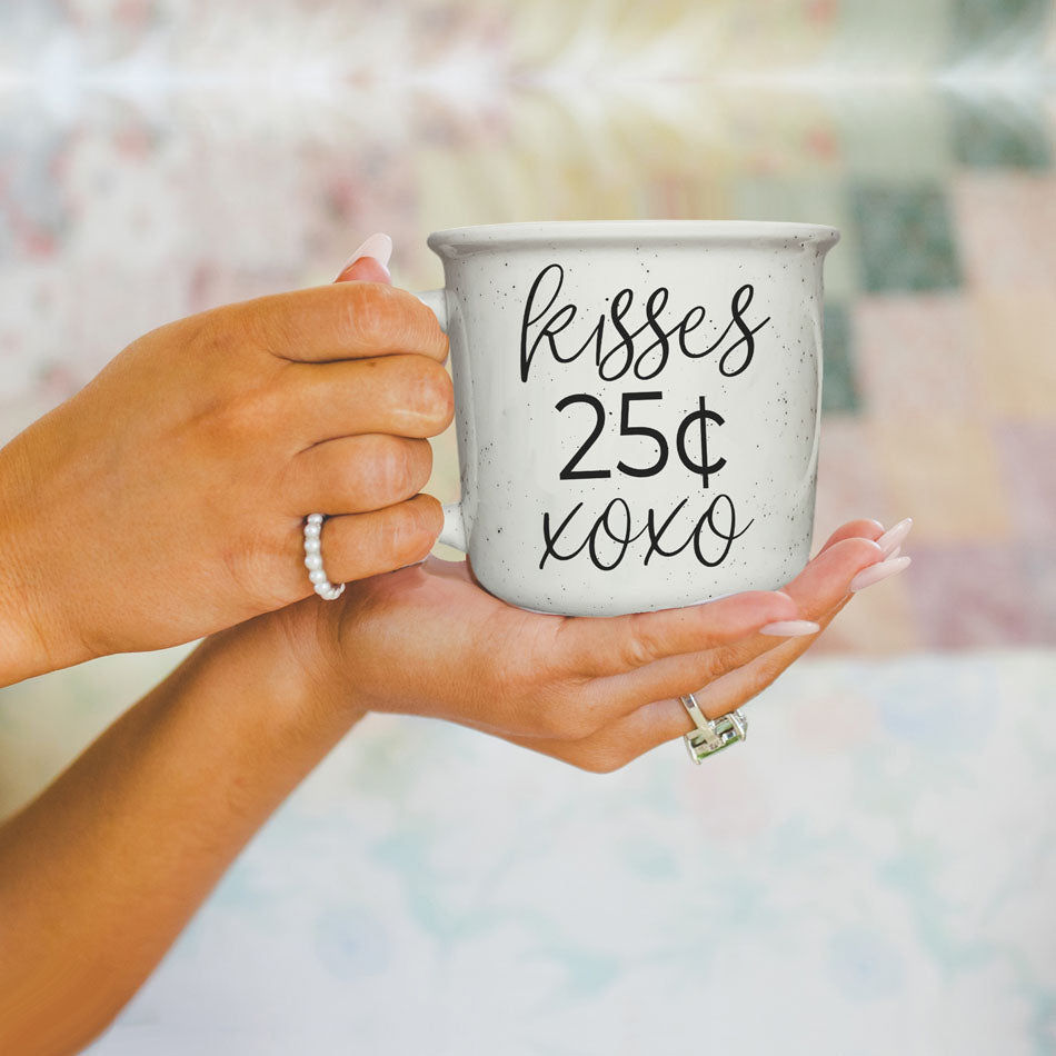 Thumbnail: Kisses 14.5oz mug with "Kisses 25 Cents" boldly printed on one side and a small "xoxo" underneath, perfect for sipping your m