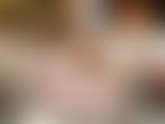 Festive table with candles, carrots, and a "Merry Christmas" plate. Decorated tree and lit fireplace create a warm holiday ambiance.