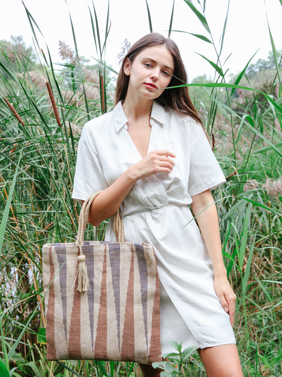 Thumbnail: women standing holding a jute tote bag