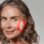 Women wearing Omnilux Skin Corrector Light Therapy Patch on cheek
