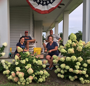 Mike and Randy sitting on the Front Porch with their wives