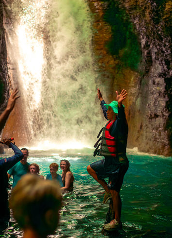 Panoramic view of La Leona Waterfall surrounded by lush rainforest.
