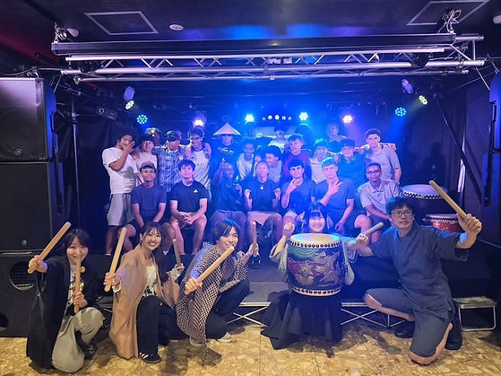     International student group posing after a taiko workshop on stage in Gion, Kyoto