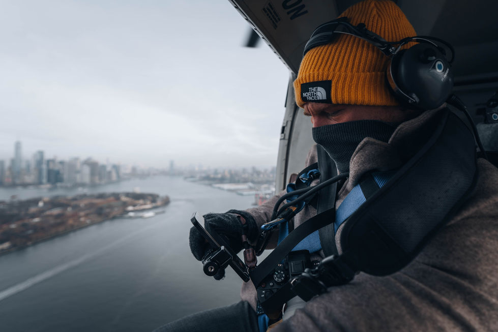 Geoffrey Munch photographing New York from helicopter above Manhattan
