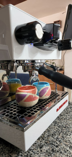 כוסות קרמיקה במכונת קפה בתהליך הכנת אספרסו.jpg