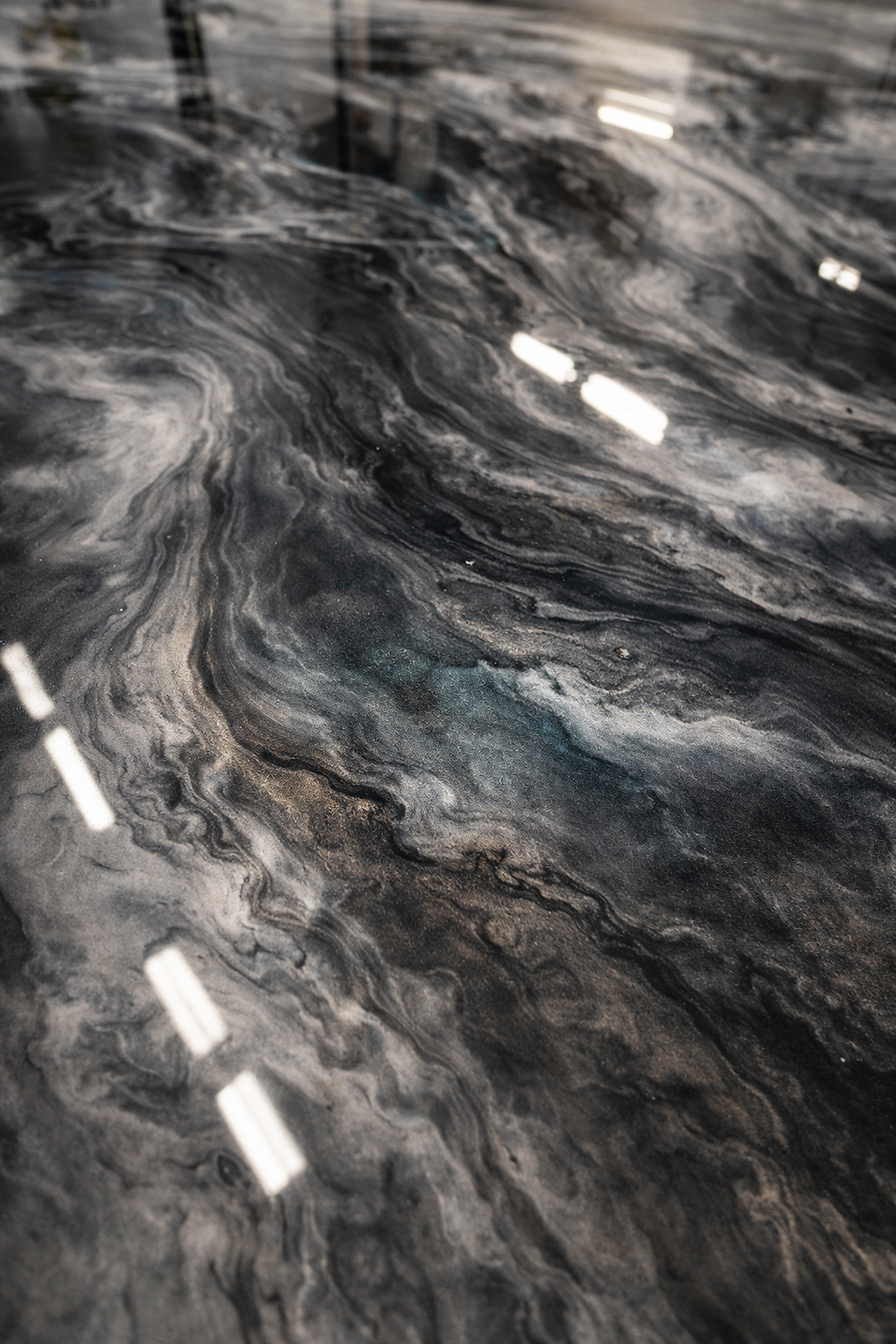Molten-esque example of an artistic epoxy floor, in grey-scale