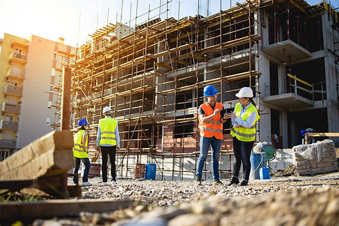 Four-construction-workers-having-meeting-scaled.jpeg