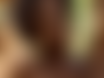 Woman with afro posing in a field