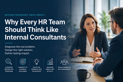 HR consultant speaks with colleague in office beside poster reading Why Every HR Team Should Think Like Internal Consultants