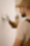 Miami handyman finishing drywall repair and painting with attention to detail