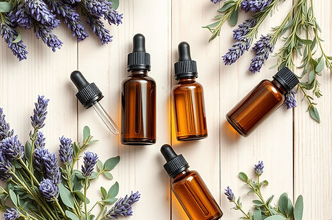Overhead flat lay of amber glass essential oil bottles with dropper caps, surrounded by fr