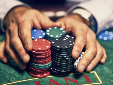 A man pushing his chips all in at poker