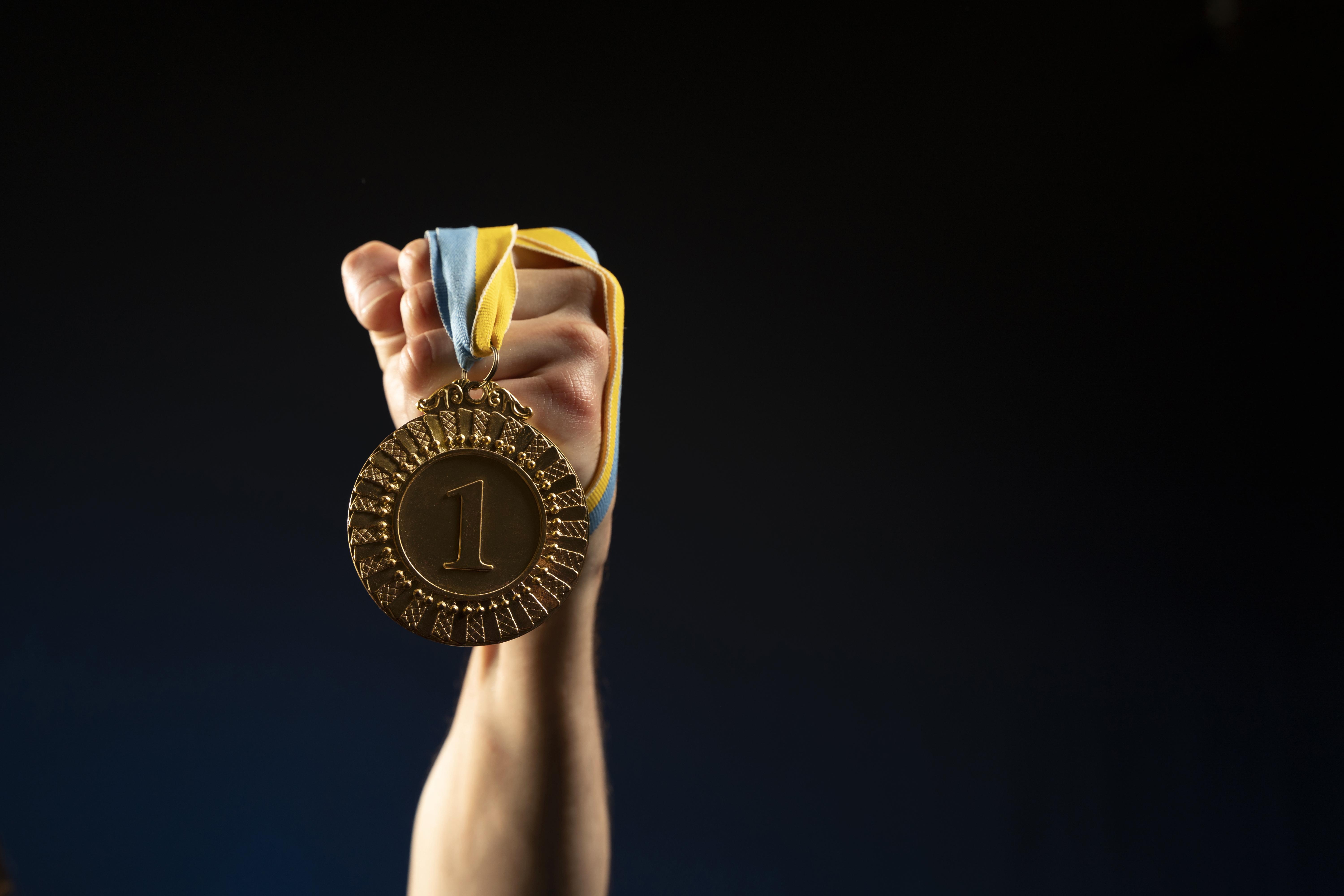 male-athlete-holding-medal.jpg