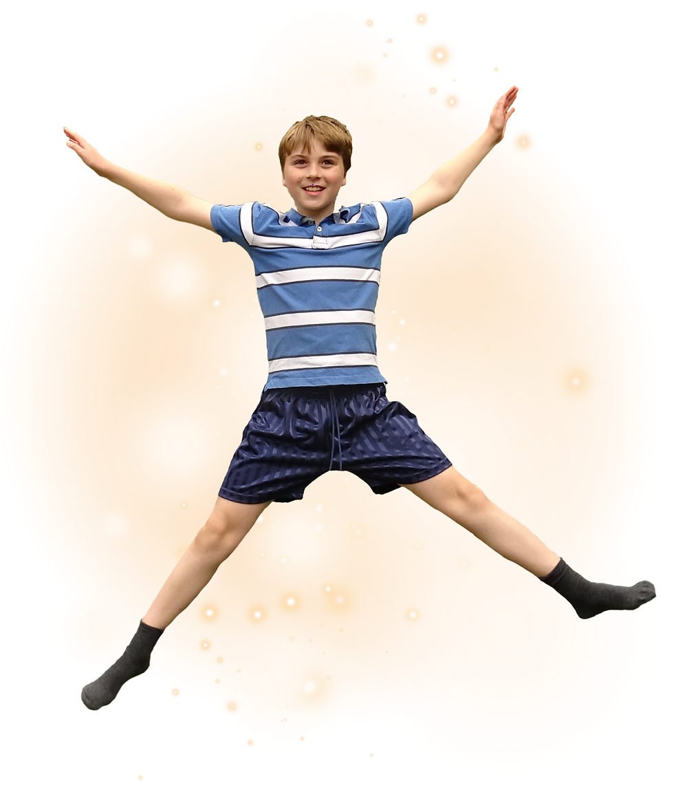 Young boy doing a star jump