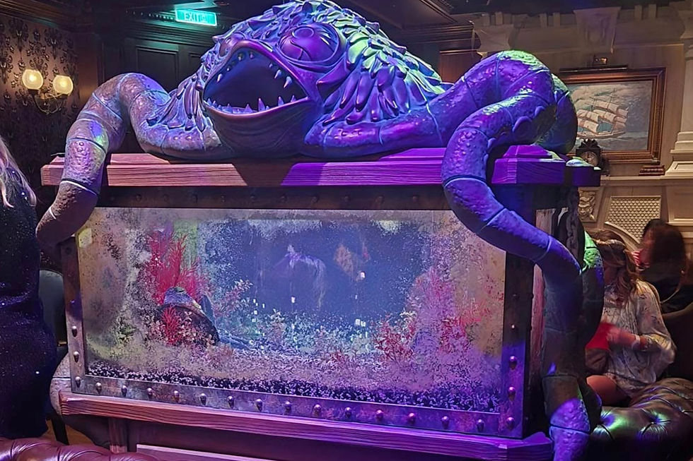 Ghostly aquarium in the centre of the Haunted Mansion Parlour on Disney Treasure