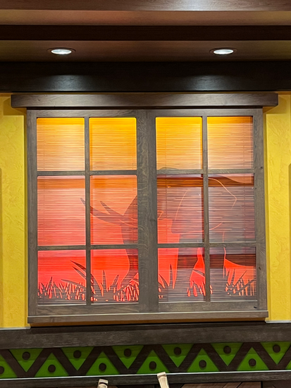 Windows with Elephant in Pride Lands Feast of the Lion King rotational dining on Disney Destiny Ship with table in front