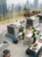 Commercial rooftop HVAC installation with workers and city skyline, construction and mechanical systems photography NYC