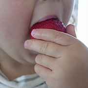 Baby eating strawberry