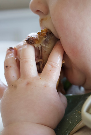 Close-up of a baby learning to safely chew and eat finger foods during the transition to solid foods.