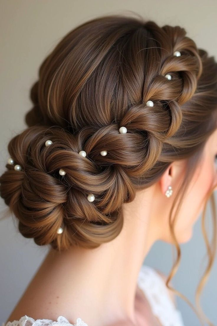 Bride showing her beautiful hair bun decorated with small pearls.