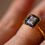 Thumbnail: Close up view of Art Deco style sapphire and diamond cluster ring.