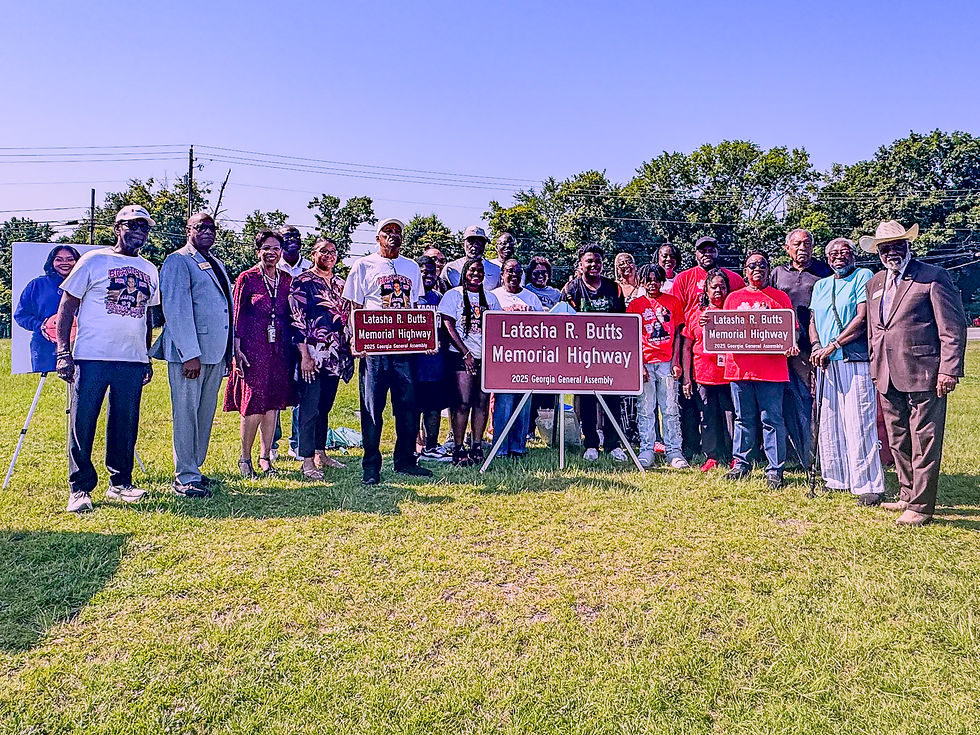 Dr. Noris Price and The Honorable Floyd Griffin, among others, join the family to commemorate this section of highway.