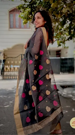 Saanjh Sakhi - A beautifully embroidered blackish grey saree with vibrant pink and gold zari designs that symbolizes the bonds of female friendship, especially in challenging times.