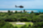 Chopper flying over island