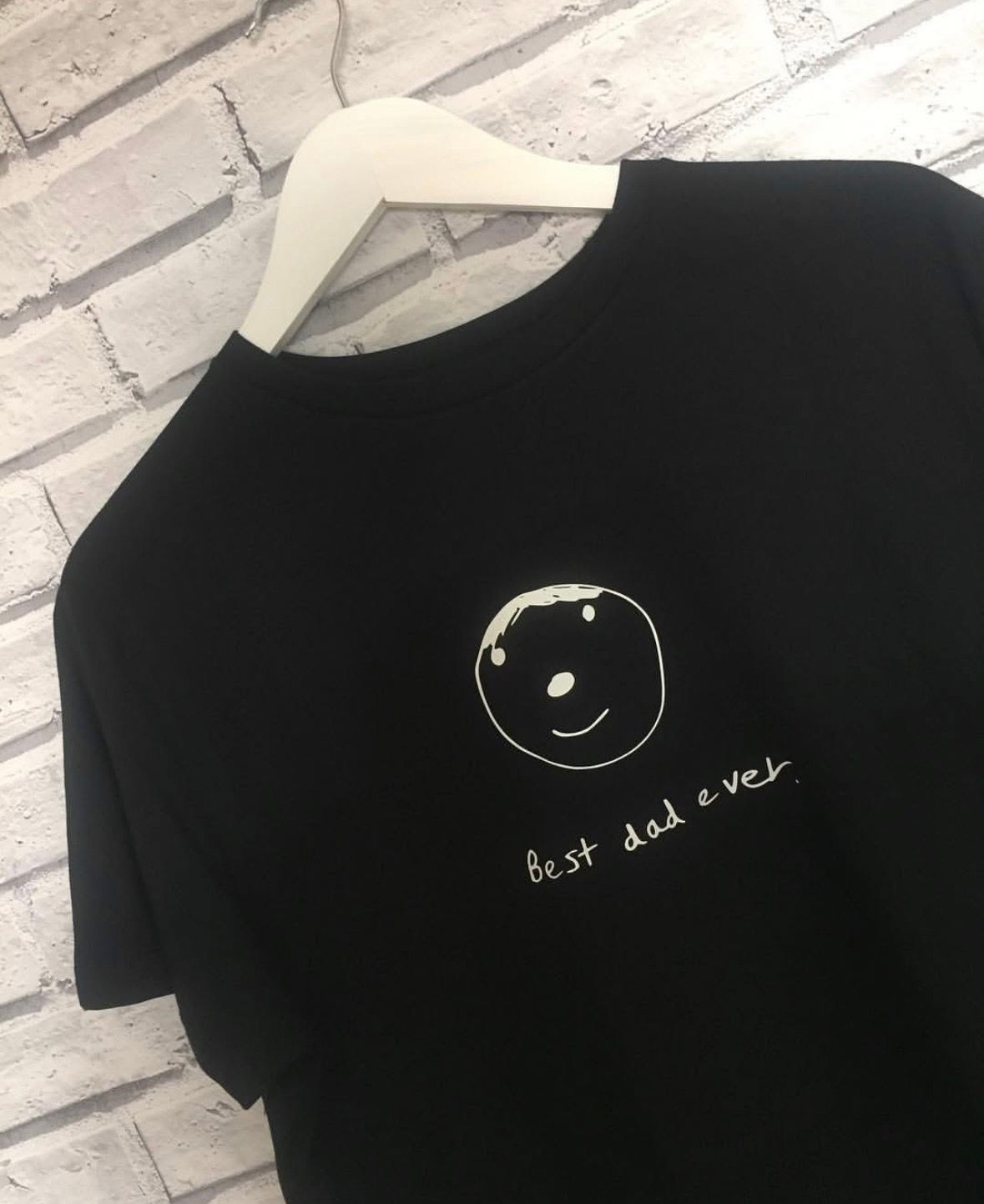 Personalised children's drawing t-shirt for dad in black, featuring a kids hand drawn smiley face and handwritten text