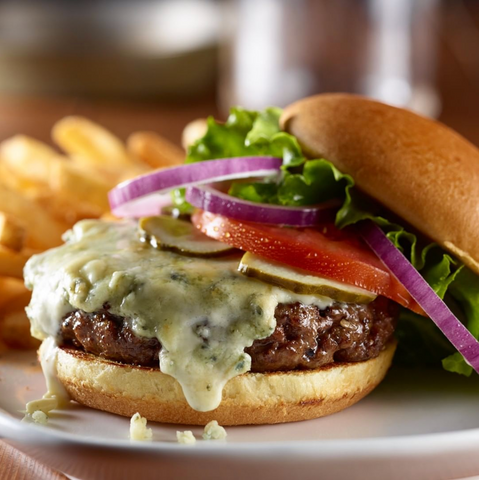 A delicious cheeseburger with its ingredients exposed.