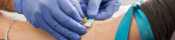 doctor drawing blood from patient