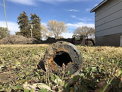 Close-up of a corroded, sludge-filled water pipe removed during the Vermillion Water Project, illustrating the deteriorated condition of the city's aging water infrastructure.