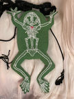 Green Underside of frog purse with white embroidered skeleton and red embroidered heart