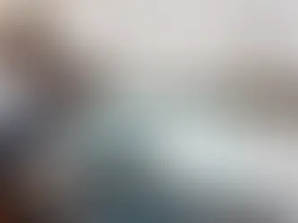 A contractor or technician performing electrical work on a subway tile wall, illustrating a phase of a home renovation where the backsplash installation cost includes specialty cutting for fixtures.