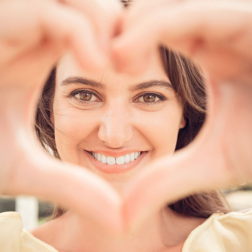 A teen girl showing love with her hands in the shape of a heart