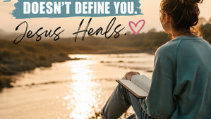 Teen girl sitting beside a peaceful river reading her Bible at sunset with the words "Your Past Doesn't Define You. Jesus Heals."