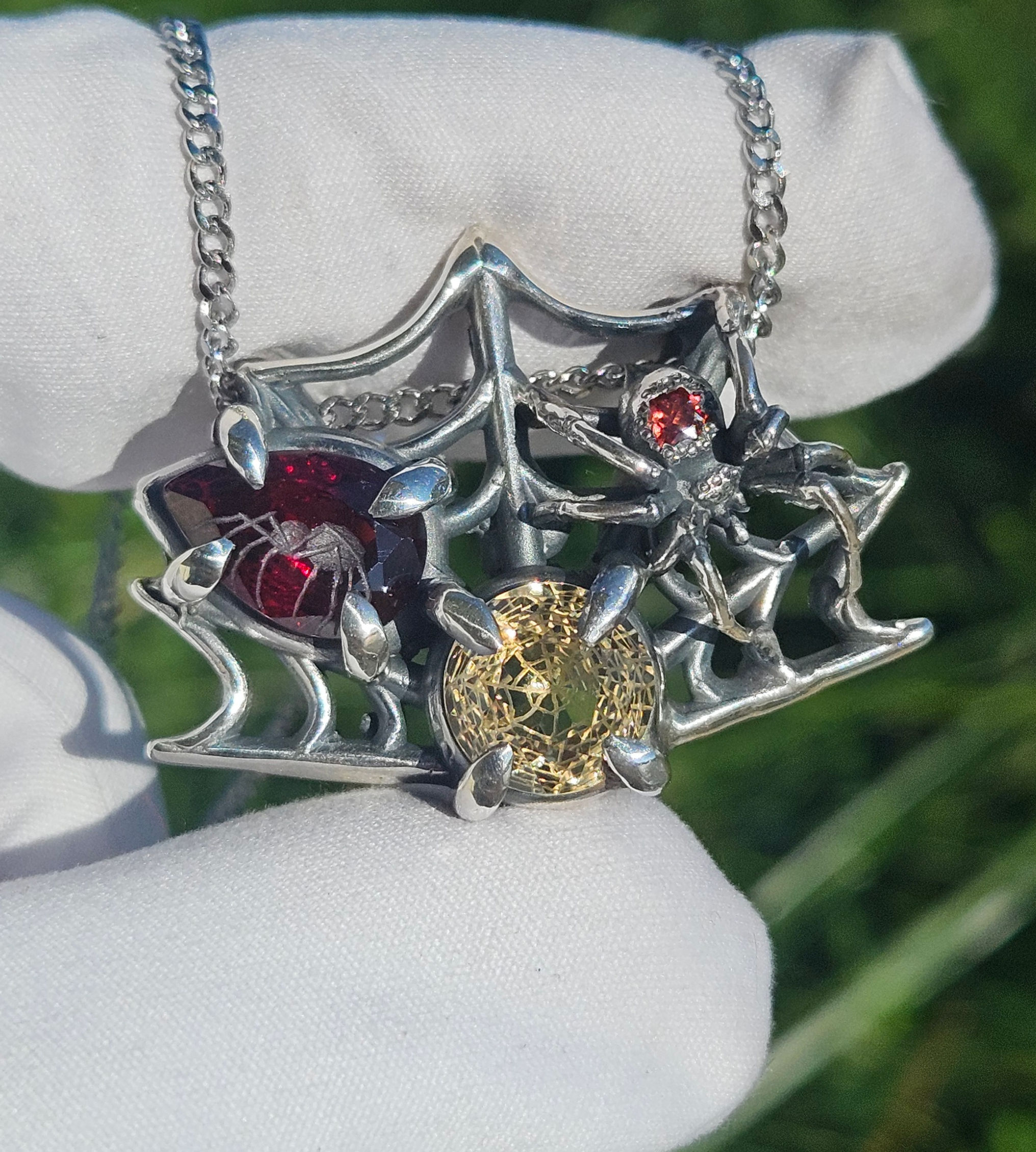 Arana - Smokey Quartz, Garnet pendant in sterling silver with spider/web carving