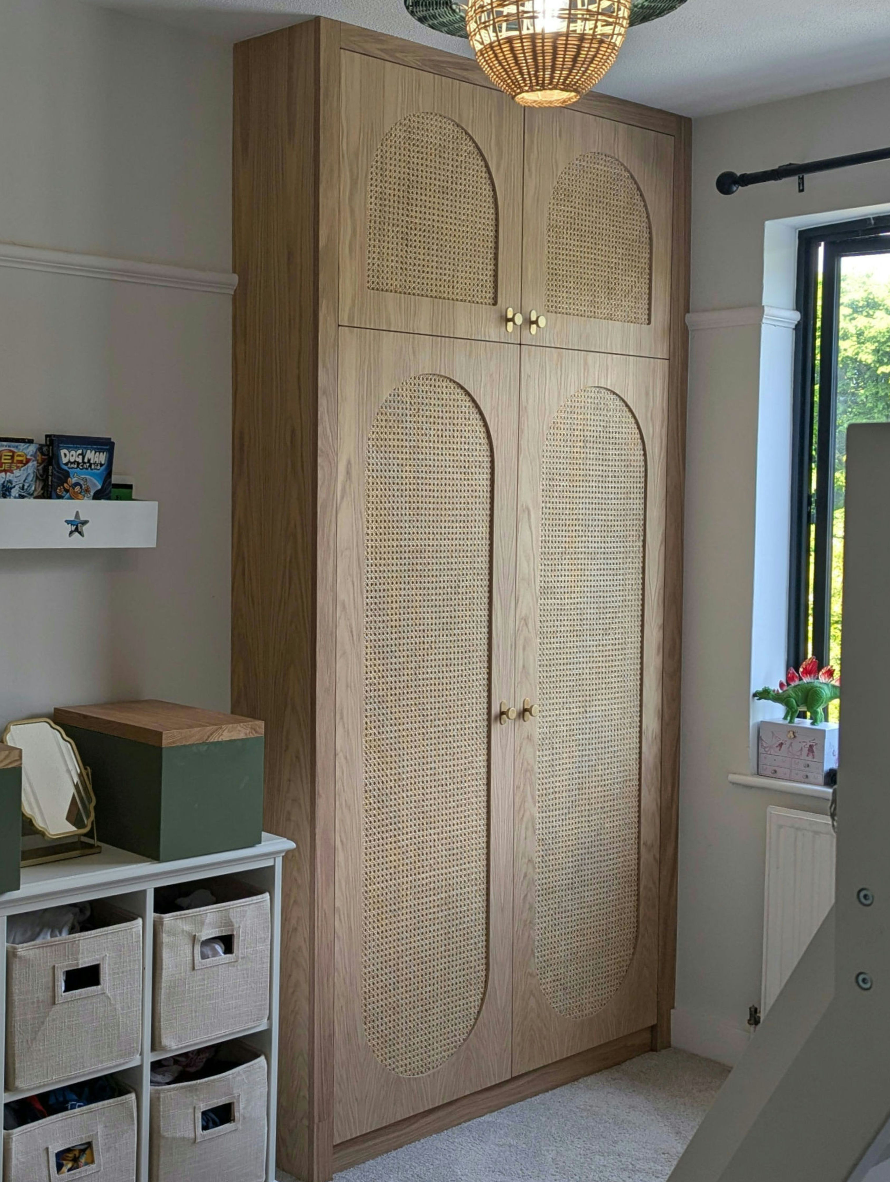 Oak veneered wardrobe with rattan inlays.