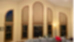 Custom arch top cellular shades fitting multiple tall curved architectural windows in an Aurora CO family room — BCC Aurora.; Get light control for unique window shapes from Blind Corners & Curves serving Denver, Breckenridge, and Vail.; Blind Corners & Curves specializes in warranty-protected specialty blinds for customers in Denver, Winter Park, and Grand Lake.;