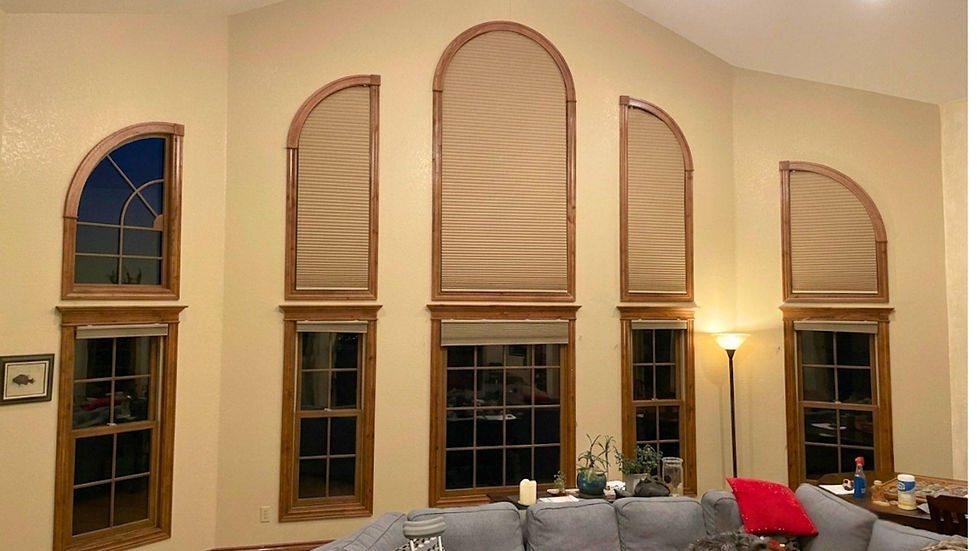 Custom arch top cellular shades fitting multiple tall curved architectural windows in an Aurora CO family room — BCC Aurora.; Get light control for unique window shapes from Blind Corners & Curves serving Denver, Breckenridge, and Vail.; Blind Corners & Curves specializes in warranty-protected specialty blinds for customers in Denver, Winter Park, and Grand Lake.;