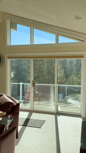 Clear blue sky and distant mountain views visible through a large uncovered upper trapezoid window in Castle Rock CO — Blind Corners and Curves.; Discover fire-resistant blind options solutions with Blind Corners & Curves across Aurora, Steamboat Springs, and Telluride.;