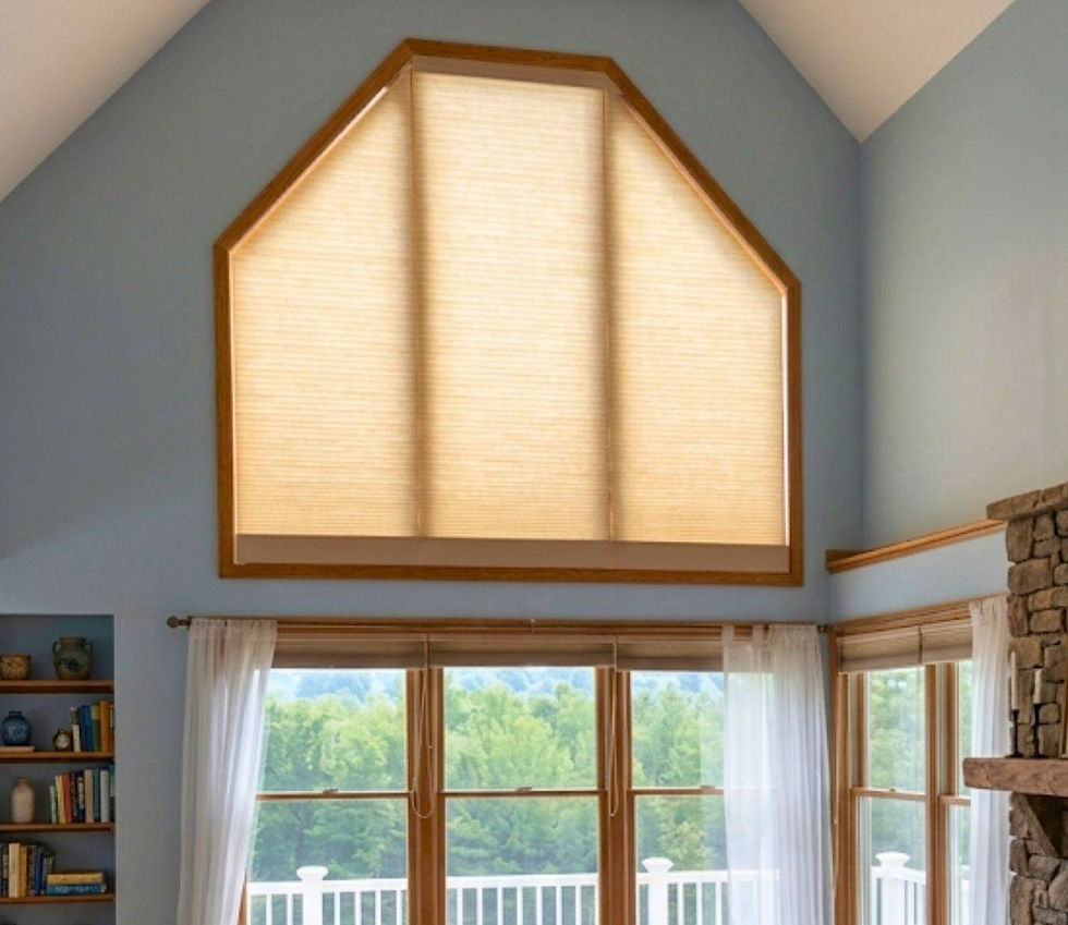 Light filtering custom honeycomb shades fully closed on a large high-set angled hexagon window in a high ceiling room — Blind Corners & Curves of Denver Colorado.; Blind Corners & Curves delivers premium anti-glare protection for shaped windows to Denver, Estes Park, and Durango.; 