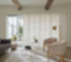 Skyline Panel-Track Blinds deliver an automated privacy solution that represents the ultimate in modern gliding window coverings for this Aurora CO living room from BCC of Denver Colorado.;
