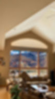 Insulating an expansive eyebrow arch window with specialized energy efficient shades in a Parker CO living area — Parker BCC.; Professional thermal insulation for specialty windows available from Blind Corners & Curves in Denver, Vail, and Steamboat Springs.; Quality voice-controlled blind operation for unique windows is available from Blind Corners & Curves serving Denver, Steamboat Springs, and Vail.; 