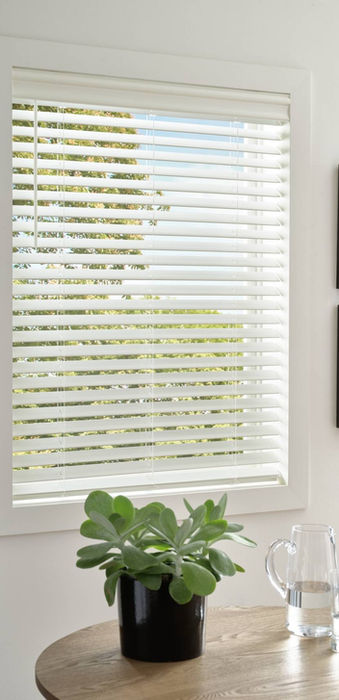 EverWood Faux Wood Blinds deliver an automated privacy solution that represents the ultimate in durable modern window coverings for this Aurora CO bedroom from BCC.;